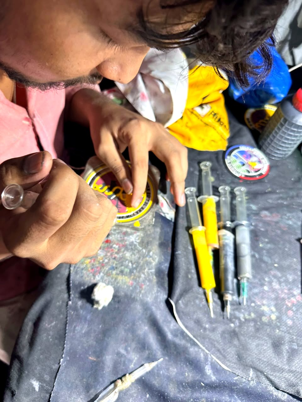 Workshop artisan mixing pigmented PVC compound by hand